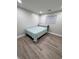 Minimalist bedroom showcasing sleek floors and a window for natural light at 3561 Bowen Pl, Indianapolis, IN 46221