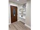 Inviting entryway with a wood door, stylish shelving, and modern decor at 3561 Bowen Pl, Indianapolis, IN 46221