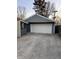 Spacious detached garage with a large white door and adjacent covered area at 3561 Bowen Pl, Indianapolis, IN 46221