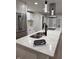 Modern kitchen island featuring a stone countertop, sleek faucet, and pendant lighting at 3561 Bowen Pl, Indianapolis, IN 46221