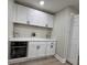 Bright kitchen features white cabinetry, modern oven, and sleek countertops at 3561 Bowen Pl, Indianapolis, IN 46221