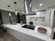 Stylish kitchen with quartz countertops, stainless steel appliances, and modern lighting at 3561 Bowen Pl, Indianapolis, IN 46221