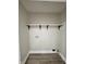 A bright laundry room with wood-style flooring and a white shelf at 3561 Bowen Pl, Indianapolis, IN 46221