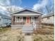 Charming craftsman-style home featuring a welcoming front porch and orange front door at 3610 Robson St, Indianapolis, IN 46201