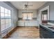 Bright kitchen featuring white cabinets, linoleum floors and large windows at 3610 Robson St, Indianapolis, IN 46201