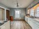 Kitchen featuring white cabinets, linoleum floors, a window, and a ceiling fan at 3610 Robson St, Indianapolis, IN 46201