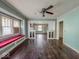 Bright living room with hardwood floors, built-in cabinets, ceiling fan and large windows at 3610 Robson St, Indianapolis, IN 46201