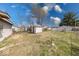View of the home's backyard, including a clothesline and a storage shed with peeling paint at 371 Cleveland St, Columbus, IN 47201