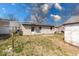 The home's backyard with a door, windows and siding is fenced and includes a clothesline at 371 Cleveland St, Columbus, IN 47201