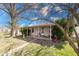Charming single-story home featuring a covered front porch and mature trees adding curb appeal at 371 Cleveland St, Columbus, IN 47201