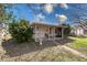 Inviting single-story home with a covered front porch and walkway through the landscaped yard at 371 Cleveland St, Columbus, IN 47201