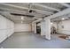 Spacious unfinished basement with painted floors, exposed ductwork, and concrete columns at 4035 N Kenwood Ave, Indianapolis, IN 46208