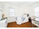 Comfortable bedroom with wood-look floors, bright light, and a classic design at 4035 N Kenwood Ave, Indianapolis, IN 46208