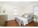 Cozy bedroom with neutral decor, wood-look floors, and bright natural light at 4035 N Kenwood Ave, Indianapolis, IN 46208