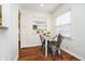 Cozy dining area with table, seating for four, a window, and decorative shelving for storage at 4035 N Kenwood Ave, Indianapolis, IN 46208