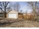 A 2-car garage with white door and a fenced yard on a sunny day at 4035 N Kenwood Ave, Indianapolis, IN 46208