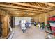 Unfinished garage with a vaulted ceiling, exposed framing, and a variety of stored items at 4035 N Kenwood Ave, Indianapolis, IN 46208