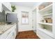 Bright kitchen with stainless steel refrigerator, granite countertops, and stylish open shelving at 4035 N Kenwood Ave, Indianapolis, IN 46208