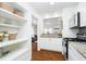 Open kitchen view with granite countertops, white cabinets, and stainless steel appliances at 4035 N Kenwood Ave, Indianapolis, IN 46208