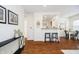 Open living space with breakfast bar, hardwood floors, and a glimpse into the adjacent dining area at 4035 N Kenwood Ave, Indianapolis, IN 46208