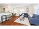 Comfortable living space featuring hardwood floors, blue sofas, and access to the dining area and kitchen at 4035 N Kenwood Ave, Indianapolis, IN 46208