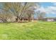 Expansive backyard features a single-story brick home, mature trees, and a well-manicured lawn at 4113 Gambel Rd, Indianapolis, IN 46221