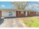 Brick and siding home with a grassy front yard and visible driveway at 4113 Gambel Rd, Indianapolis, IN 46221