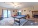 Spacious living room featuring a pool table, fireplace, and sliding glass doors at 4113 Gambel Rd, Indianapolis, IN 46221