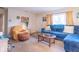 Inviting living room showcasing a plush blue sofa, neutral walls, and carpet flooring at 4113 Gambel Rd, Indianapolis, IN 46221