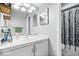Neutral toned bathroom with modern vanity and lighting, plus an updated shower with modern enclosure at 4307 Dahlia Ct, Indianapolis, IN 46220