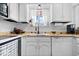 Kitchen sink with updated faucet, white cabinets, and white appliances at 4307 Dahlia Ct, Indianapolis, IN 46220
