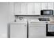 Bright laundry area featuring a washing machine, dryer, and white cabinets for ample storage at 4307 Dahlia Ct, Indianapolis, IN 46220