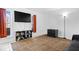 Bright living room with light walls, a brown grid pattern rug, and minimalist furniture at 4307 Dahlia Ct, Indianapolis, IN 46220