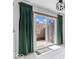 Sliding glass doors with green curtains that lead to an outdoor deck at 4307 Dahlia Ct, Indianapolis, IN 46220