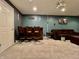 Finished basement with a wet bar, brown leather sofa, neutral carpet, and projector at 4309 Worchester Ct, Carmel, IN 46033