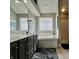 Bright bathroom featuring double vanity, soaking tub, and separate shower for convenience and relaxation at 4309 Worchester Ct, Carmel, IN 46033