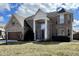 Two-story brick home with a two-car garage and a turret on a sunny day at 4309 Worchester Ct, Carmel, IN 46033
