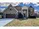 Two-story brick home with a two-car garage and a turret on a sunny day at 4309 Worchester Ct, Carmel, IN 46033