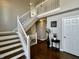 Bright foyer with hardwood floors and an open staircase at 4309 Worchester Ct, Carmel, IN 46033