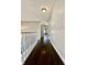 Hallway with gleaming hardwood floors and a staircase at 4309 Worchester Ct, Carmel, IN 46033