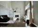 Bright living room featuring a fireplace, high ceilings, and a large window with natural light at 4309 Worchester Ct, Carmel, IN 46033