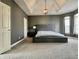 The beautiful main bedroom features a tray ceiling, modern light fixture, and lots of natural light at 4309 Worchester Ct, Carmel, IN 46033