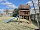 Backyard with a wooden playset, slide, and swing at 4309 Worchester Ct, Carmel, IN 46033
