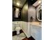 Stylish powder room features wainscoting, modern fixtures, and hardwood floors for a sophisticated look at 4309 Worchester Ct, Carmel, IN 46033