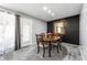 Inviting dining room with dark accent wall, wood table and chairs, and decorative mirror at 4501 N Wheeling Ave # 6A - 201, Muncie, IN 47304