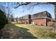 Exterior shot of a brick apartment building with a well-maintained lawn and mature trees in the background at 4501 N Wheeling Ave # 6A - 201, Muncie, IN 47304
