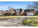 Side view of brick home featuring second story balcony, mature trees and green lawn at 4501 N Wheeling Ave # 6A - 201, Muncie, IN 47304
