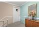 Inviting foyer with front door, wood cabinet, mirror, and colorful floral arrangement at 4501 N Wheeling Ave # 6A - 201, Muncie, IN 47304
