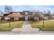 Charming brick home with well-manicured lawn, mature trees, and inviting walkway at 4501 N Wheeling Ave # 6A - 201, Muncie, IN 47304