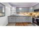 Bright kitchen showcases gray cabinetry, stainless steel appliances, stone countertops, and a window above the sink at 4501 N Wheeling Ave # 6A - 201, Muncie, IN 47304